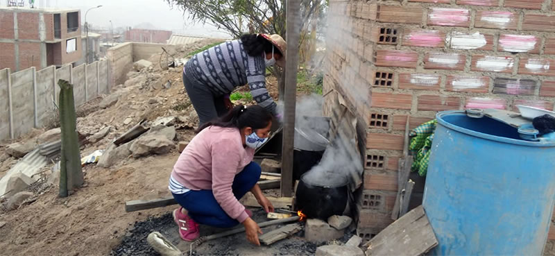 Cooking food outside over wood fires