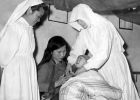 Two Sisters helping a mother with her baby in China